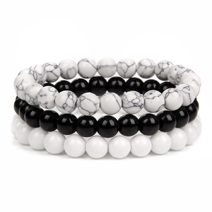 Detail of 8mm natural stone bead bracelet set with black onyx and white marble textures