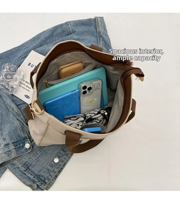 Detail view of large canvas tote bag interior with multiple compartments and high capacity