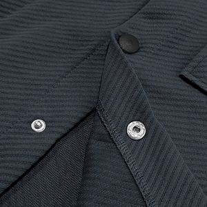 Macro shot of dark grey heavy twill fabric texture and metallic snap button closure