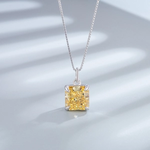 Macro shot of a square yellow gemstone pendant with 925 sterling silver box chain