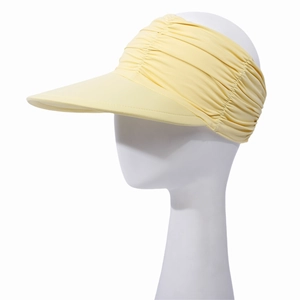 Detail of light yellow sun visor featuring pleated cooling fabric and a wide protective brim
