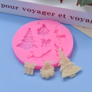 Pink silicone mold for Christmas trees and reindeer with finished white soap pieces