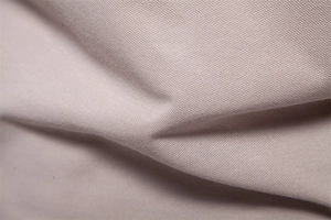 Close-up of khaki polo shirt fabric showing breathable micro-mesh texture and soft knit weave