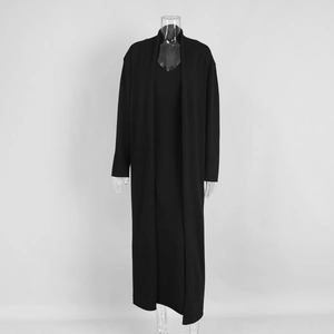 Detail of black knitted long cardigan and V-neck maxi dress set on a mannequin