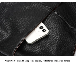 Detail of the magnetic closure pocket on black leather bag with large capacity for phone