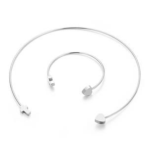 Polished silver stainless steel jewelry set featuring heart and cross open choker and bracelet