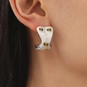 Modern white C-shaped hoop earrings with yellow leopard pattern and marble texture