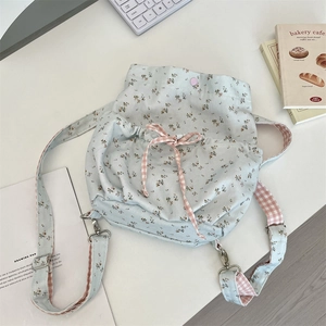 Floral canvas backpack with pink checkered drawstring detail and adjustable straps