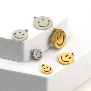 Macro view of gold and silver smiley face charms in various sizes on white blocks