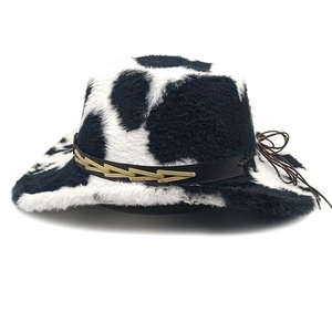Detail of cow print cowboy hat with brown leather band and intricate braided textures