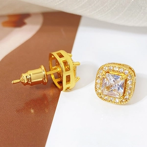 Detailed macro view of gold-plated square halo stud earrings with princess cut crystal