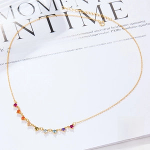 Macro shot of S925 sterling silver gold chain with rainbow cubic zirconia gemstones