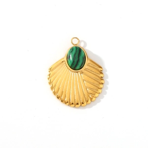Macro shot of a golden shell pendant featuring an oval green malachite stone inlay