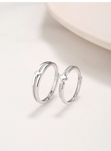 Detailed macro view of S925 sterling silver couple rings with star relief and diamonds
