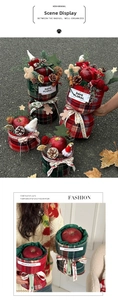 Detail view of a plaid Christmas gift bucket with apple, pine cones, and Merry Christmas ribbon