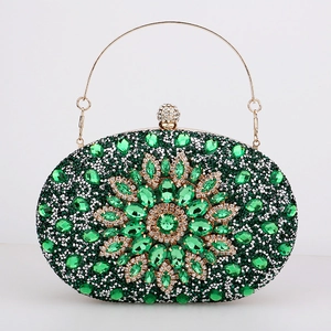 Detailed macro view of green crystal flower clutch with gold frame and spherical clasp