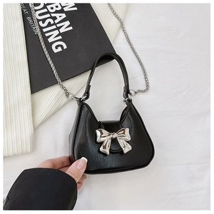 Trendy black PU leather handbag for women featuring a stylish silver bow and chain strap