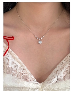 Close-up of S925 silver necklace with square pink zircon pendant worn on a model's neck