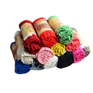 Colorful winter knitted baby scarves stacked in pyramid style with paper packaging labels