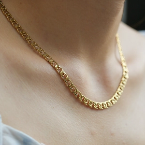 Flat curb chain necklace in polished gold finish on model for street style look