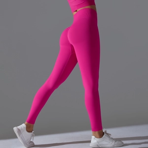 Detail of high-waist seamless bright pink yoga pants showing push-up peach lift effect