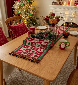 Detailed view of Christmas table runner featuring plaid patterns, reindeer, and tassels
