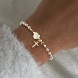 Détail du bracelet en perles avec pendentif cœur lettre M doré et breloque croix pavée