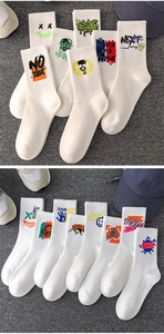 Detail view of white cotton crew socks featuring colorful street style graffiti patterns
