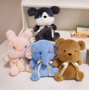 Close-up of four plush animals including a bear and bunny with Woody Friends ribbons