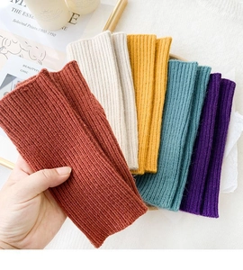 Detailed view of textured rib-knit arm warmers in various autumn colors and soft fabric