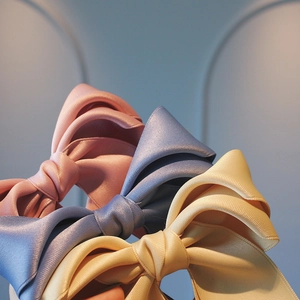 Classic satin ribbon bow hair clips for girls in pink, blue, and beige pastel colors