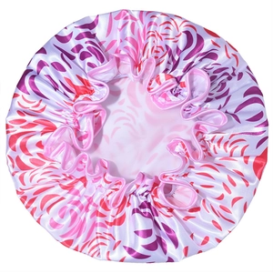 Detail of waterproof satin shower cap with elastic band and purple wave patterns