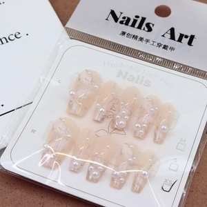 Pink press-on nails with silver marble patterns and pearl charms in 10-piece set