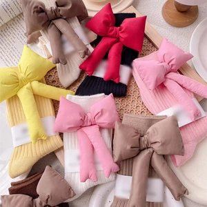 Colorful knitted cotton slouch socks with large fabric bows in five different colors