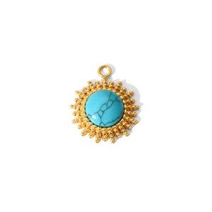 Detailed macro view of a gold-plated sunburst pendant with a turquoise center stone