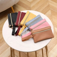 Porte-monnaie en polyester de plusieurs couleurs disposés sur une table en marbre