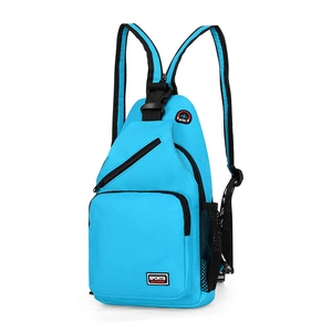 Detail of blue nylon chest bag showing the side mesh pocket and multiple zip compartments