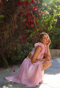 Detail of pink floral maxi dress with ruffle shoulders and open back design