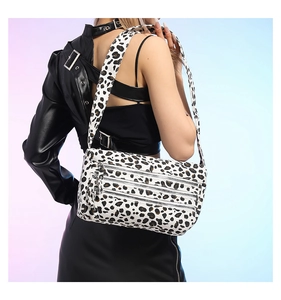 Détail du sac léopard avec trois compartiments zippés et une large bandoulière ajustable