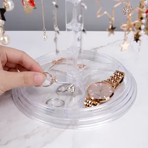 Rotating acrylic jewelry organizer with star hooks and base tray for earrings and necklaces