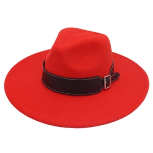 Detailed view of a red wide-brim fedora hat with a black leather band and silver buckle