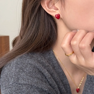 Retro style jewelry set with red heart zircon earrings and necklace worn by a model