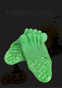 Close-up of funny green giant monster feet slippers for Halloween costume parties