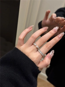 Detail of silver pearl open ring set with micro-pave cubic zirconia on hand