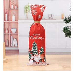 Close-up of red Christmas wine bottle cover with Santa Claus print on wooden table