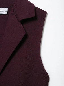 Close-up detail of burgundy knit vest with classic notched lapel and size label