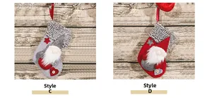 Detail of Christmas gnomes on grey and red knitted stockings with wooden buttons