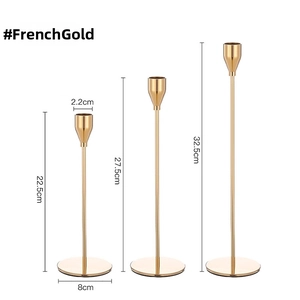 Three-piece French Gold metal candle holders in varied heights showing size details