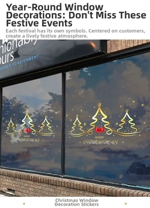 Macro detail of gold Christmas tree window decals with red bows and Merry Christmas text
