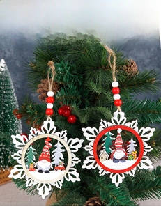 Close-up of triple-layer wooden snowflake ornament featuring gnomes on a Christmas tree